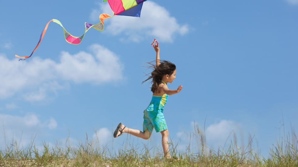 Child running with kite